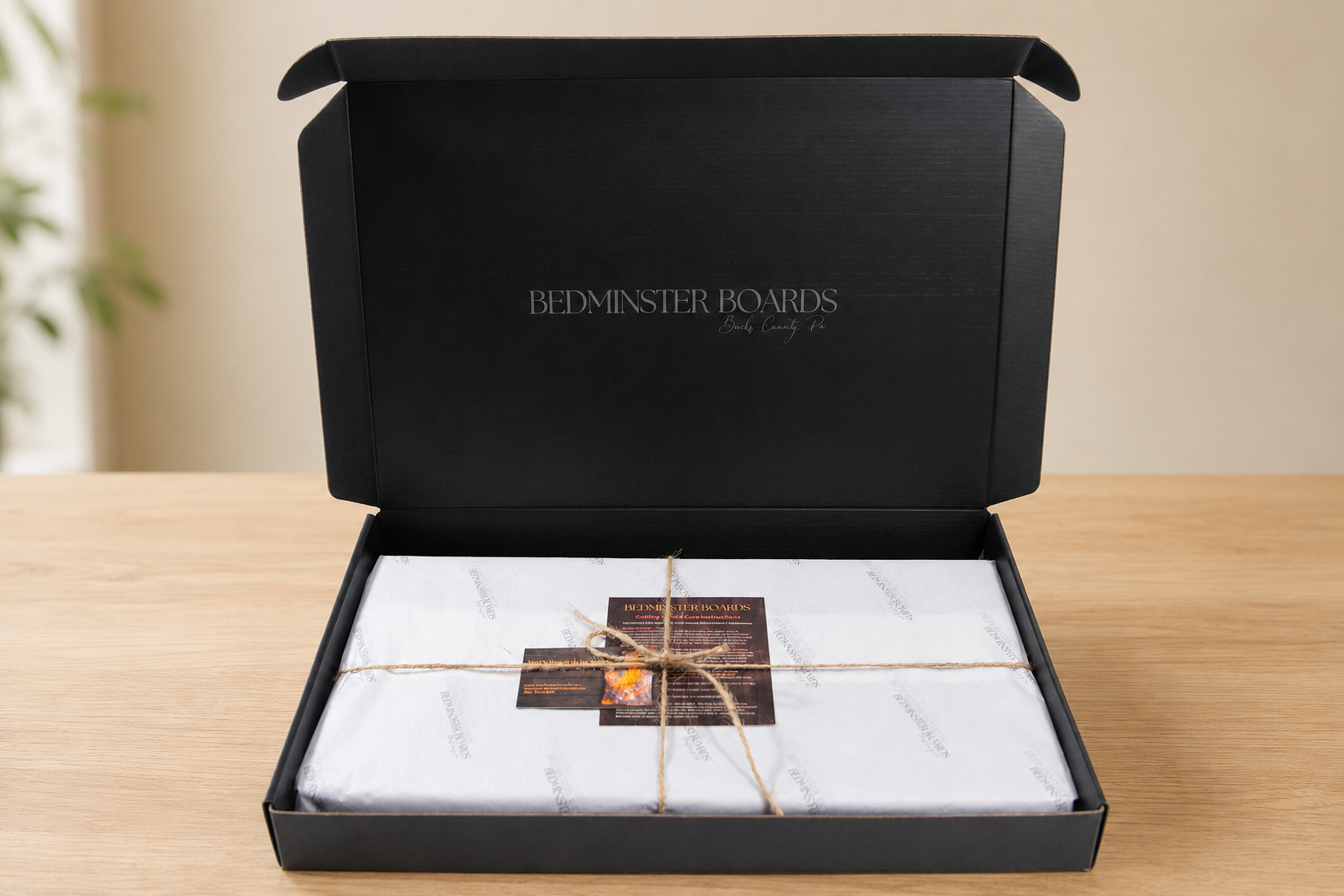 Open Bedminster Boards presentation box with tissue, twine and care materials