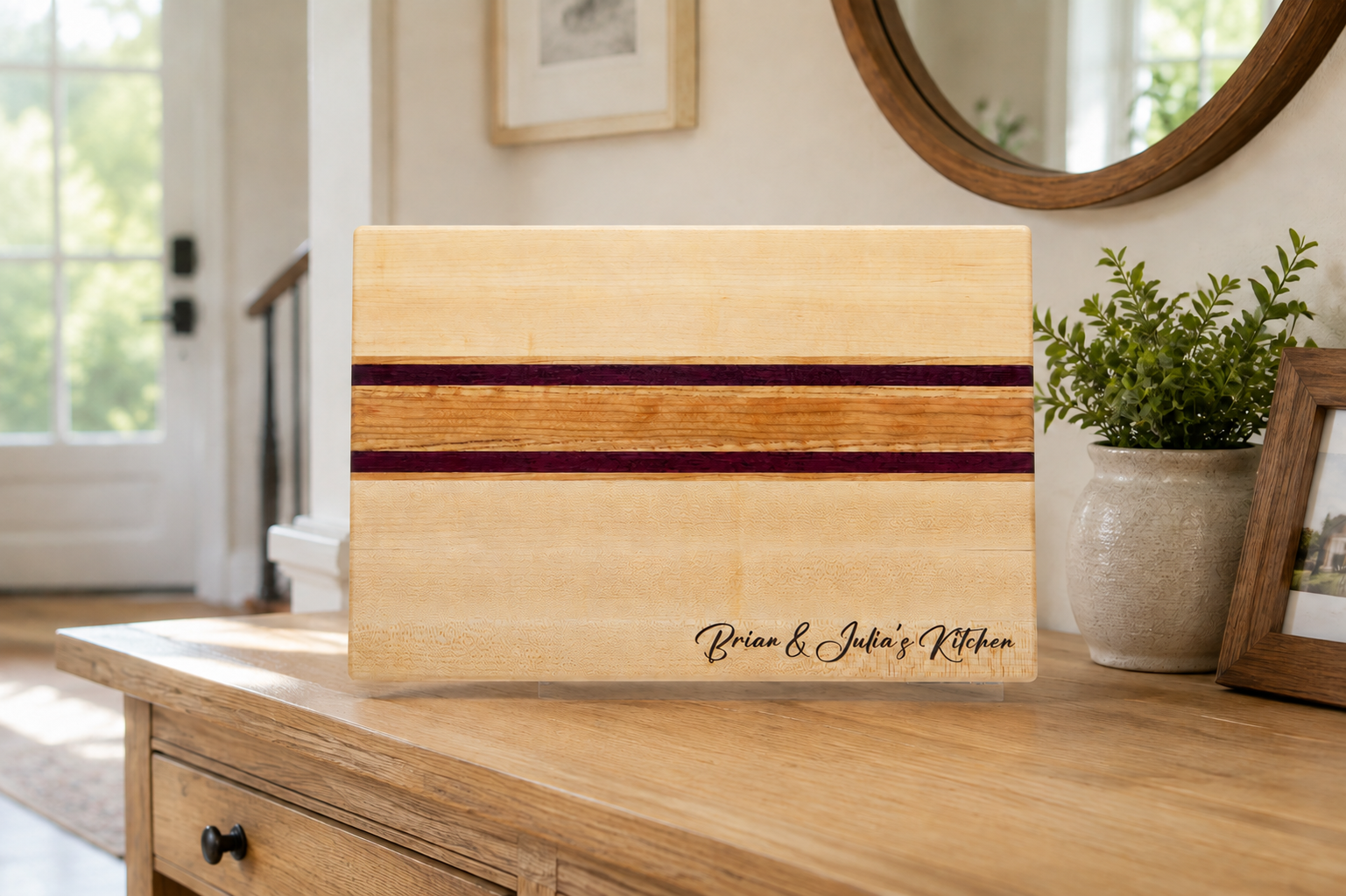 Brian and Julia personalized maple and purpleheart kitchen board displayed in a bright home entryway