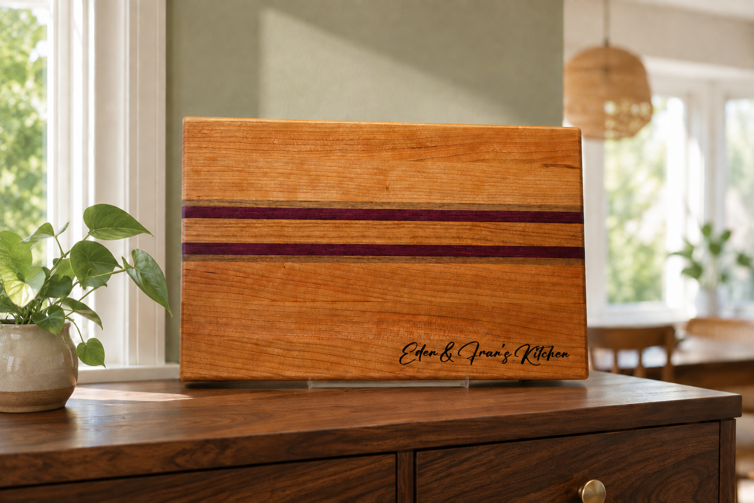 Eden and Fran personalized cherry and purpleheart kitchen board displayed in a sunlit dining room